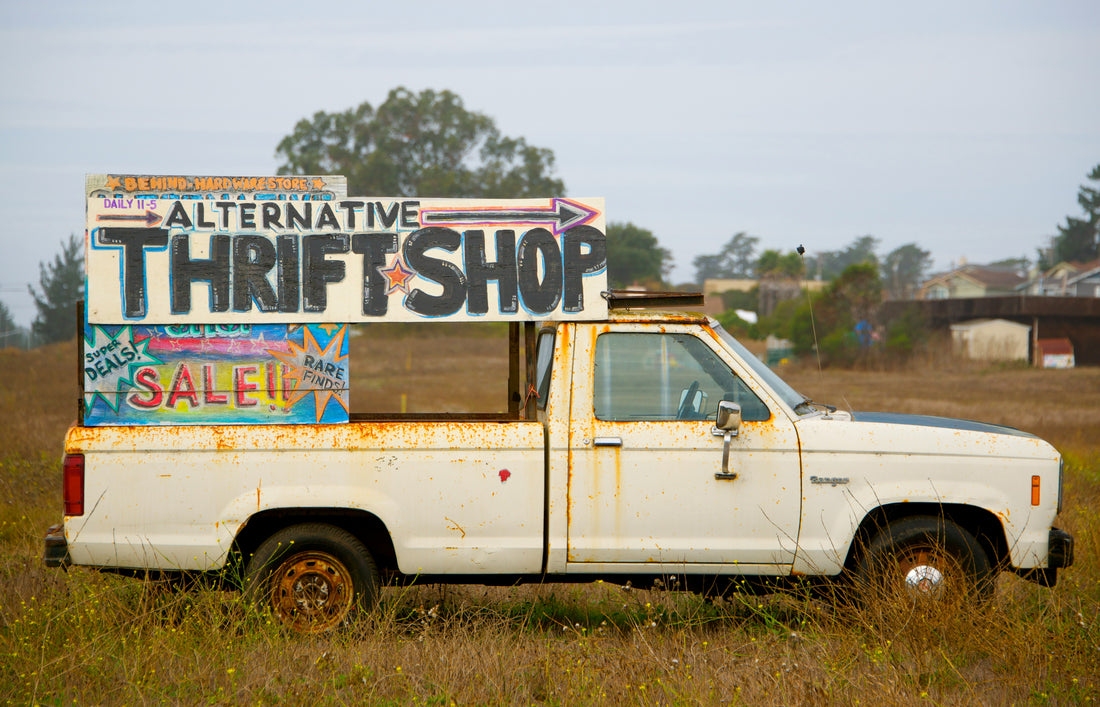 a truck with a thrift shop sign as example to a thrift shop